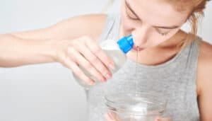 Woman doing nasal rinsing